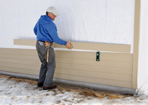 contractor installing fiber cement siding